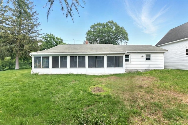 42 Jacob St, Chicopee, MA 01020 - rear view of property with a sunroom, a yard, and a chimney