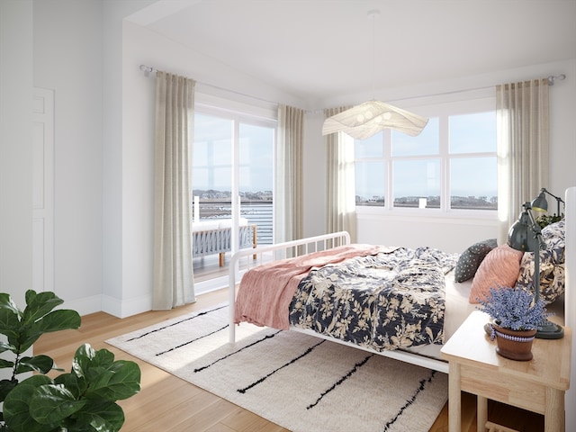 bedroom with light hardwood / wood-style flooring and multiple windows