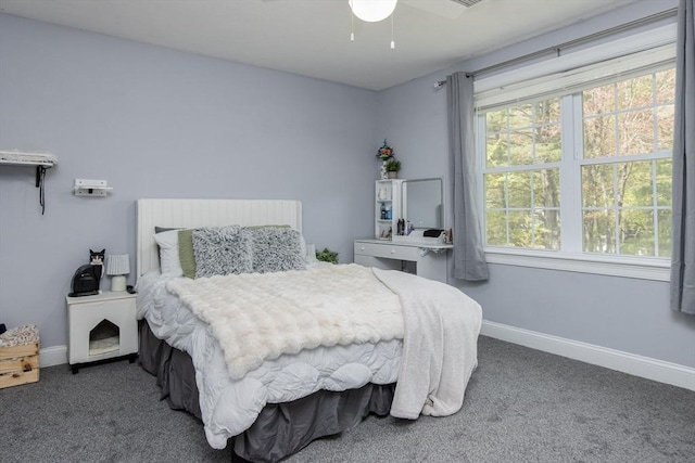 carpeted bedroom featuring baseboards and ceiling fan