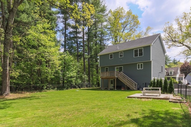 back of house featuring stairs and a wooden deck