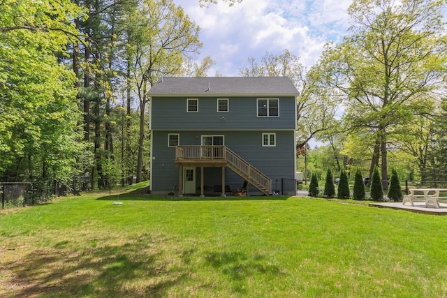 rear view of property featuring a wooden deck and stairway