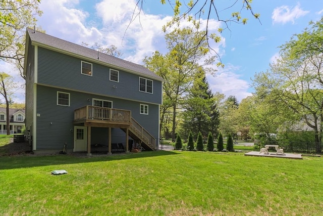 rear view of property with stairway and a wooden deck