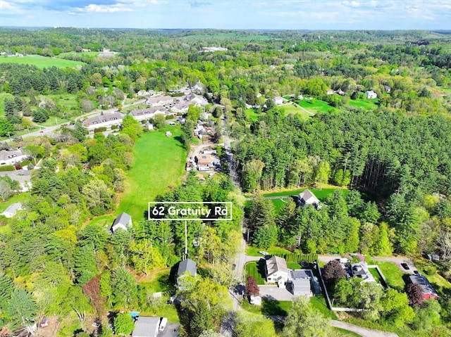 aerial perspective of suburban area with a heavily wooded area and property boundaries highlighted