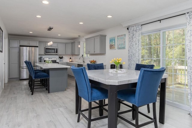 dining space featuring recessed lighting and light wood-type flooring