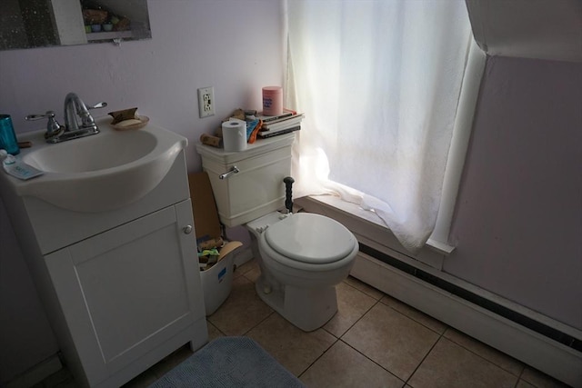 half bathroom with a baseboard radiator, tile patterned floors, vanity, and toilet