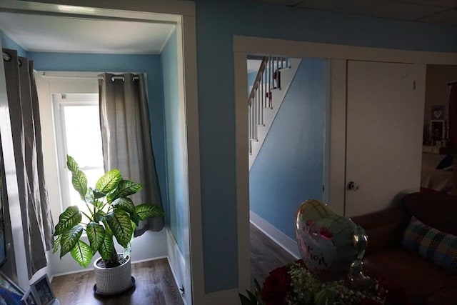 living area featuring stairway, wood finished floors, and baseboards
