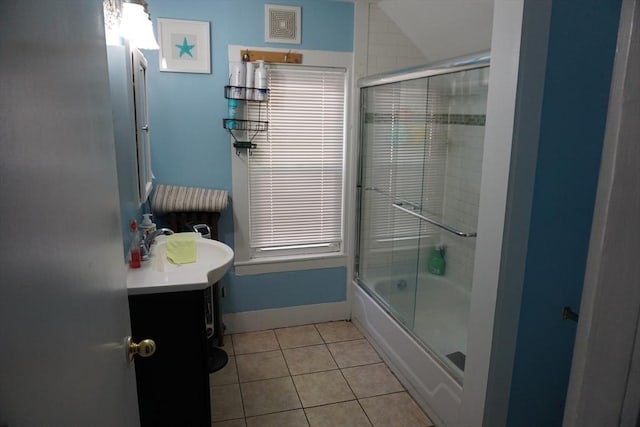 bathroom with tile patterned floors, vanity, combined bath / shower with glass door, and vaulted ceiling