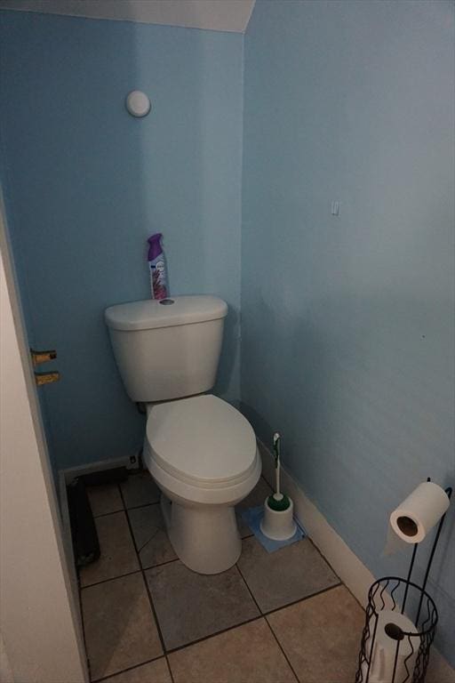 bathroom featuring toilet, tile patterned floors, and baseboards