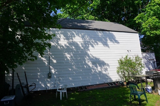 view of property exterior featuring a lawn