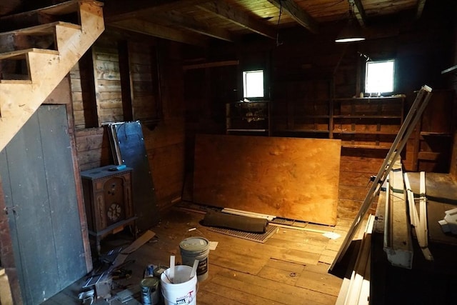 below grade area featuring wood walls and hardwood / wood-style flooring