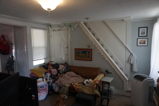 living room with stairway and ornamental molding
