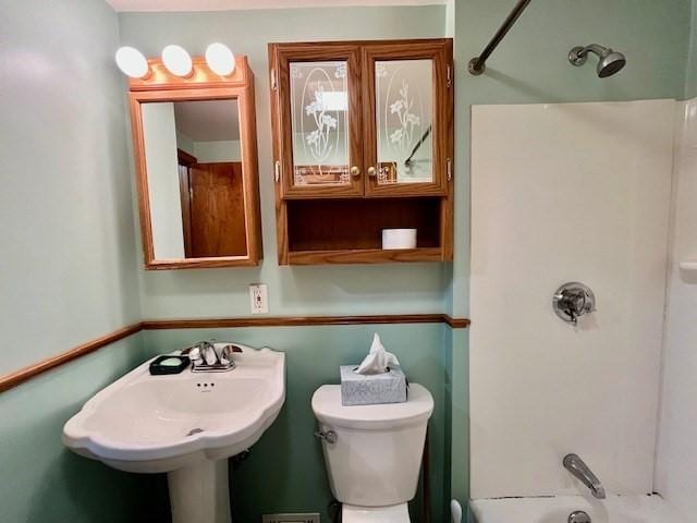 full bath with tub / shower combination, toilet, and a sink