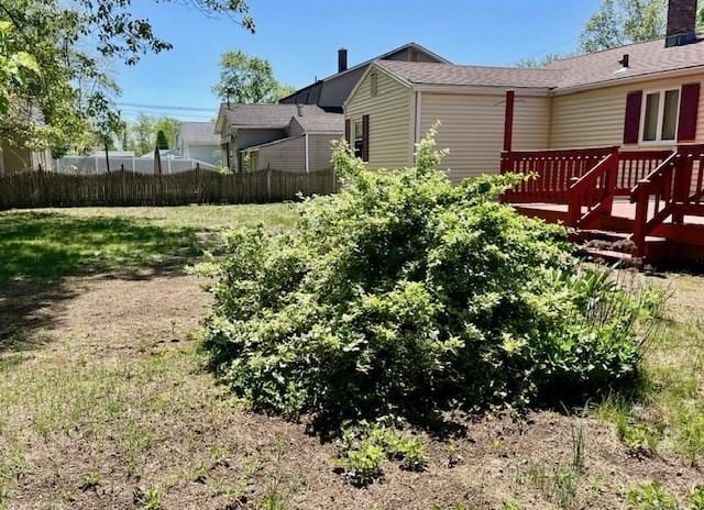 view of yard featuring a deck and fence