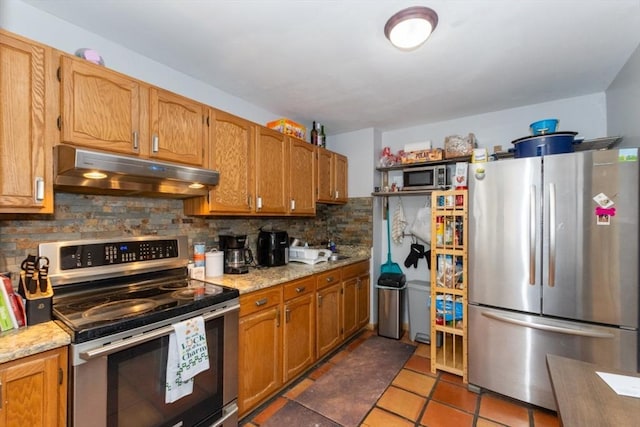5 Linda Ln Unit 2-2, Boston, MA 02125 - kitchen with stainless steel appliances, under cabinet range hood, tasteful backsplash, light tile patterned floors, and light stone counters
