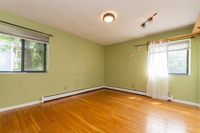 5 Linda Ln Unit 2-2, Boston, MA 02125 - empty room with a baseboard radiator, light wood finished floors, baseboards, and rail lighting