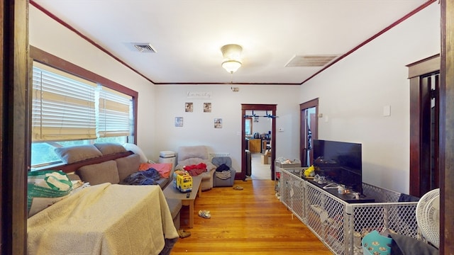 bedroom featuring light hardwood / wood-style floors and ornamental molding