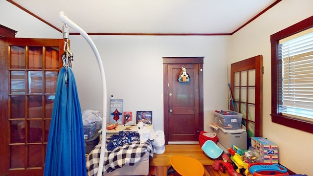 bedroom with wood-type flooring and crown molding