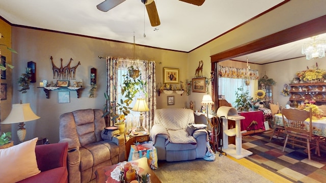 living room featuring ceiling fan with notable chandelier, hardwood / wood-style flooring, and crown molding