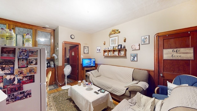 living room with wooden walls and hardwood / wood-style floors