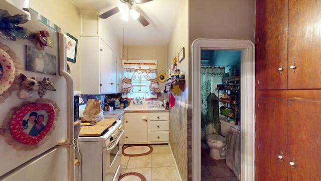 kitchen with ceiling fan, white cabinets, light tile patterned flooring, and white appliances