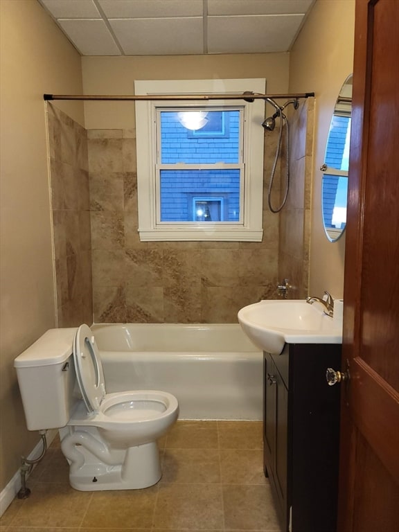 full bathroom featuring tile patterned floors, tiled shower / bath combo, vanity, and toilet