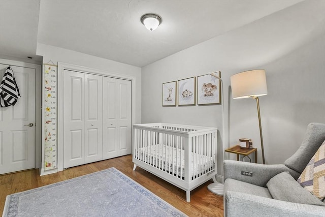 29 Maple St Unit C, Canton, MA 02021 - bedroom featuring wood finished floors, a closet, and a nursery area
