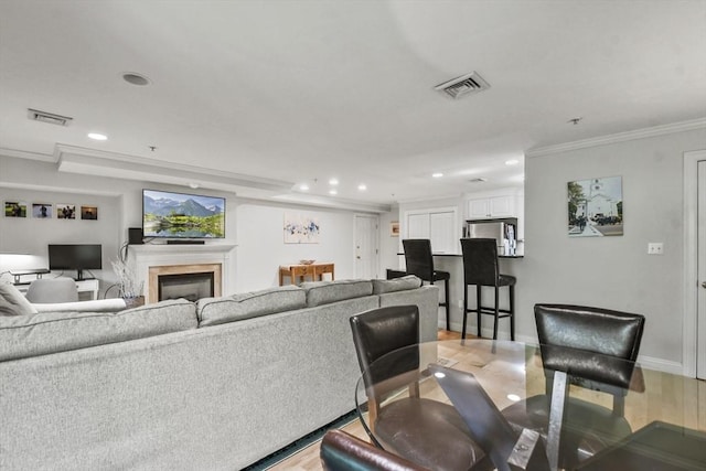 29 Maple St Unit C, Canton, MA 02021 - living room featuring recessed lighting, light wood-style flooring, ornamental molding, and a fireplace