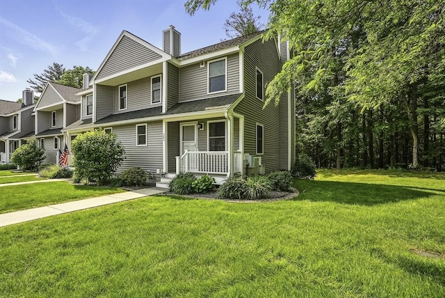 205 Bayberry Hill Ln Unit 205, Leominster, MA 01453 - view of front facade featuring a chimney, a front lawn, and a porch