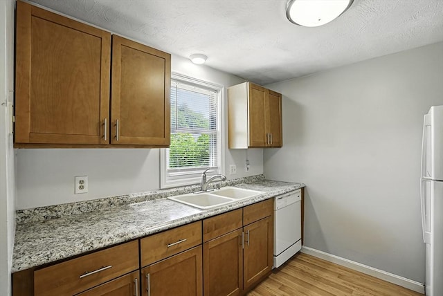 205 Bayberry Hill Ln Unit 205, Leominster, MA 01453 - kitchen with white appliances, light wood finished floors, and brown cabinets