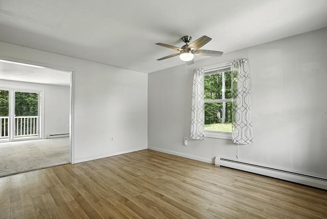 205 Bayberry Hill Ln Unit 205, Leominster, MA 01453 - empty room with plenty of natural light, a baseboard heating unit, a ceiling fan, and wood finished floors
