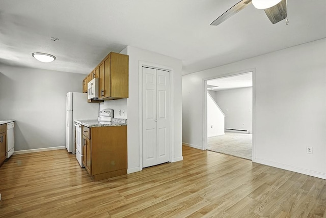 205 Bayberry Hill Ln Unit 205, Leominster, MA 01453 - kitchen featuring white appliances, brown cabinets, a ceiling fan, and light wood-style floors