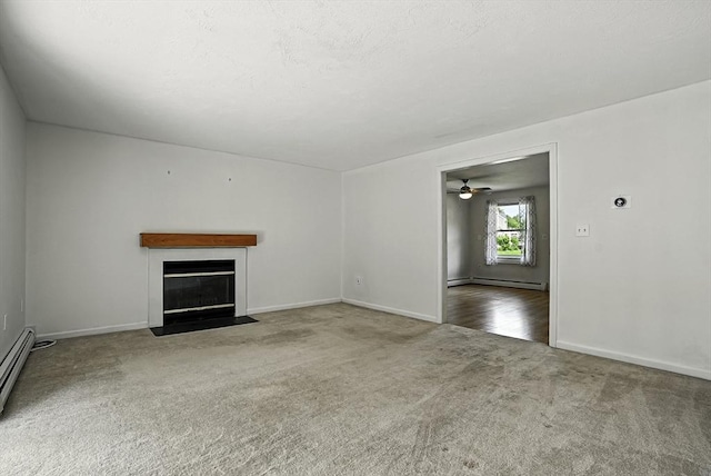 205 Bayberry Hill Ln Unit 205, Leominster, MA 01453 - unfurnished living room featuring carpet, baseboard heating, a fireplace with flush hearth, a baseboard radiator, and ceiling fan