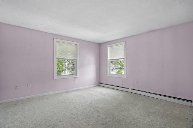 205 Bayberry Hill Ln Unit 205, Leominster, MA 01453 - spare room with plenty of natural light, a baseboard heating unit, and carpet floors
