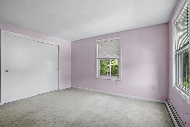 205 Bayberry Hill Ln Unit 205, Leominster, MA 01453 - unfurnished bedroom featuring a baseboard radiator, carpet, and a closet