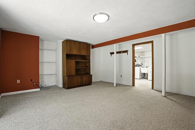 205 Bayberry Hill Ln Unit 205, Leominster, MA 01453 - unfurnished living room featuring light carpet, a textured ceiling, and washer / dryer