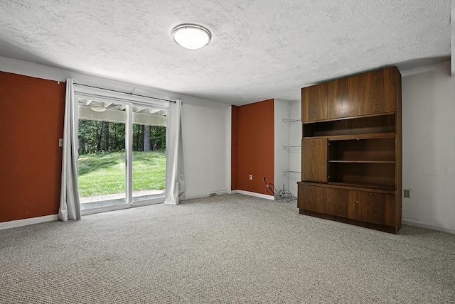 205 Bayberry Hill Ln Unit 205, Leominster, MA 01453 - unfurnished living room featuring a textured ceiling and light carpet