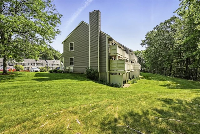 205 Bayberry Hill Ln Unit 205, Leominster, MA 01453 - view of side of property featuring a chimney and a lawn