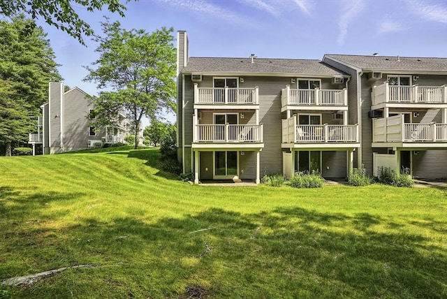205 Bayberry Hill Ln Unit 205, Leominster, MA 01453 - rear view of house with a yard, a chimney, and a balcony