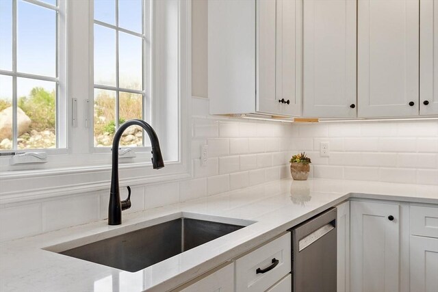 16 Dean Ln Unit 16, Littleton, MA 01460 - kitchen with a sink, dishwasher, white cabinetry, and tasteful backsplash