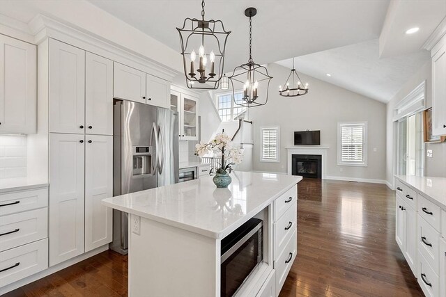 16 Dean Ln Unit 16, Littleton, MA 01460 - kitchen with stainless steel appliances, a chandelier, lofted ceiling, open floor plan, and white cabinetry