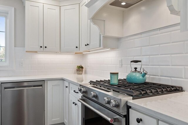 16 Dean Ln Unit 16, Littleton, MA 01460 - kitchen featuring appliances with stainless steel finishes, white cabinetry, and decorative backsplash