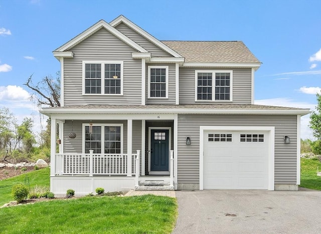 16 Dean Ln Unit 16, Littleton, MA 01460 - view of front of home with covered porch, driveway, a garage, a shingled roof, and a front lawn