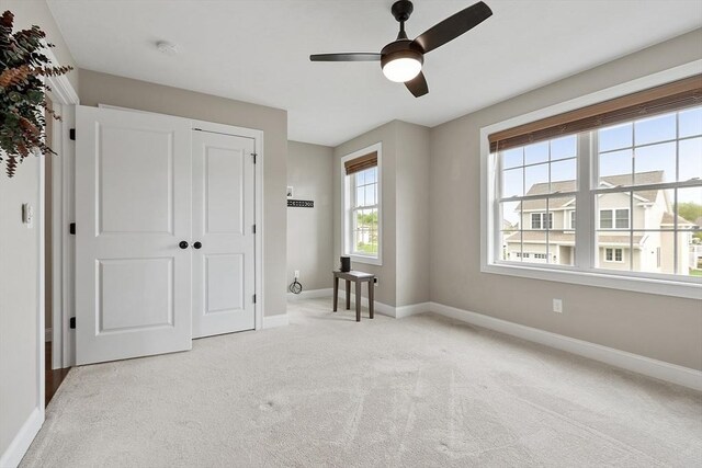 16 Dean Ln Unit 16, Littleton, MA 01460 - unfurnished bedroom with baseboards, light carpet, a ceiling fan, and a closet