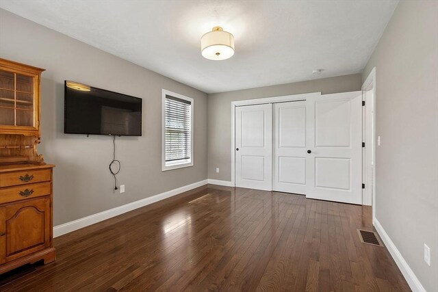 16 Dean Ln Unit 16, Littleton, MA 01460 - unfurnished bedroom featuring dark wood-type flooring, a closet, and baseboards
