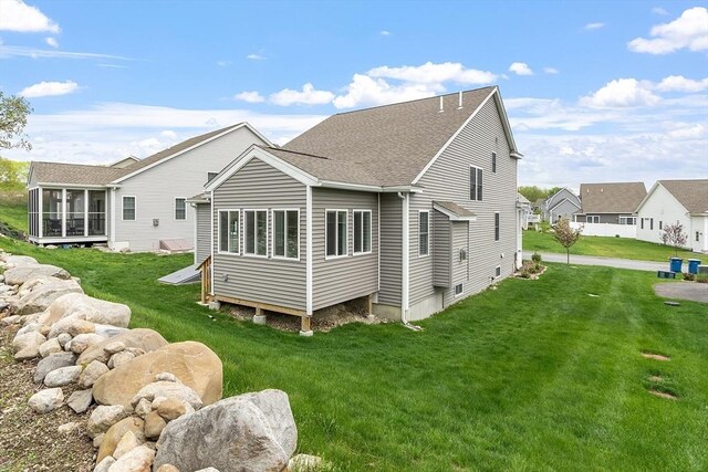 16 Dean Ln Unit 16, Littleton, MA 01460 - rear view of house featuring a sunroom, a shingled roof, and a yard