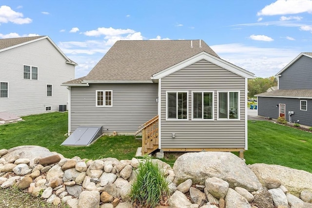 16 Dean Ln Unit 16, Littleton, MA 01460 - back of property featuring a lawn, a shingled roof, and central AC