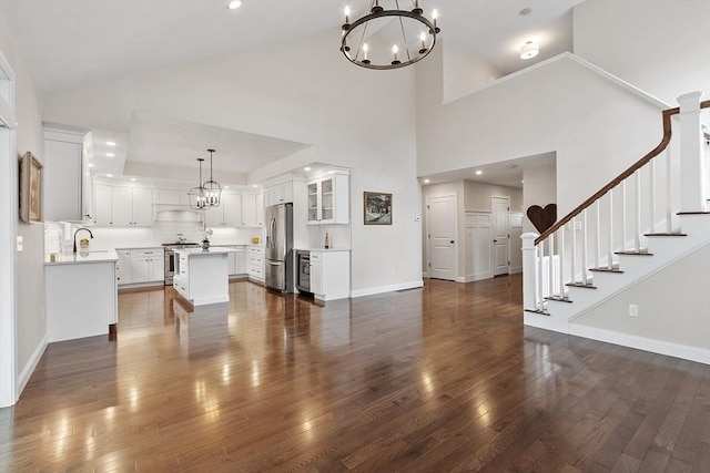 16 Dean Ln Unit 16, Littleton, MA 01460 - unfurnished living room featuring stairs, a sink, a chandelier, dark wood-style floors, and recessed lighting