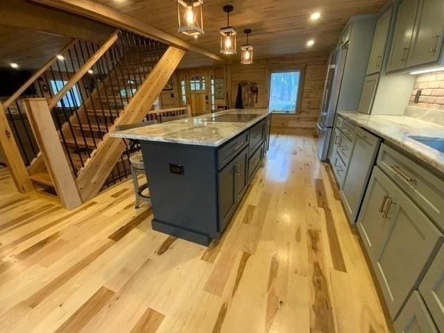 80 Populatic St, Franklin, MA 02038 - kitchen featuring light wood-style flooring, dishwasher, decorative light fixtures, a breakfast bar, and a center island