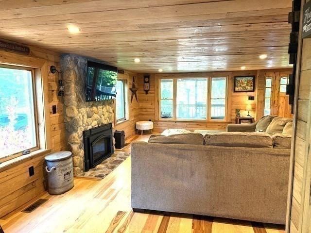80 Populatic St, Franklin, MA 02038 - living area featuring wooden ceiling, wood finished floors, a fireplace, and wood walls