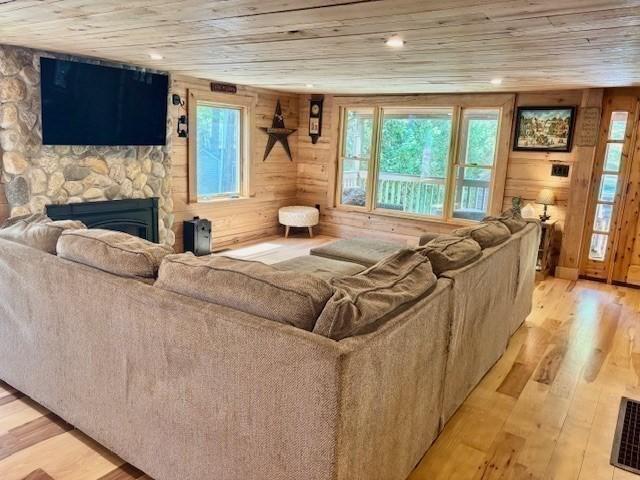 80 Populatic St, Franklin, MA 02038 - living area featuring light wood-style flooring, wood ceiling, a fireplace, and wood walls